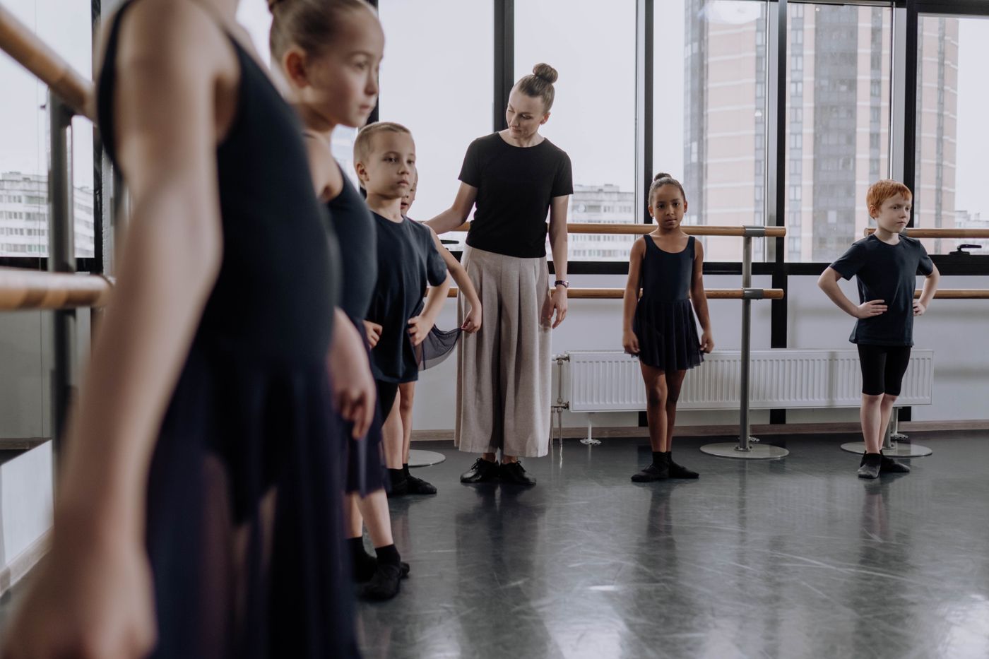 Children learning to dance in a class with their instructor