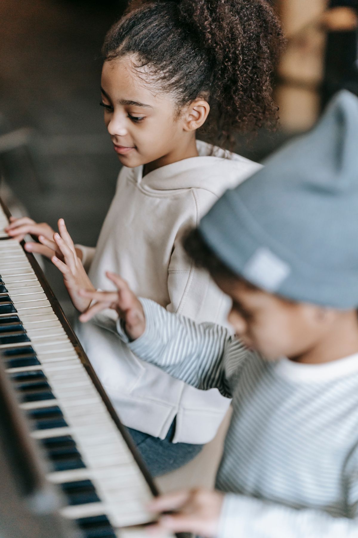 Children learning the piano